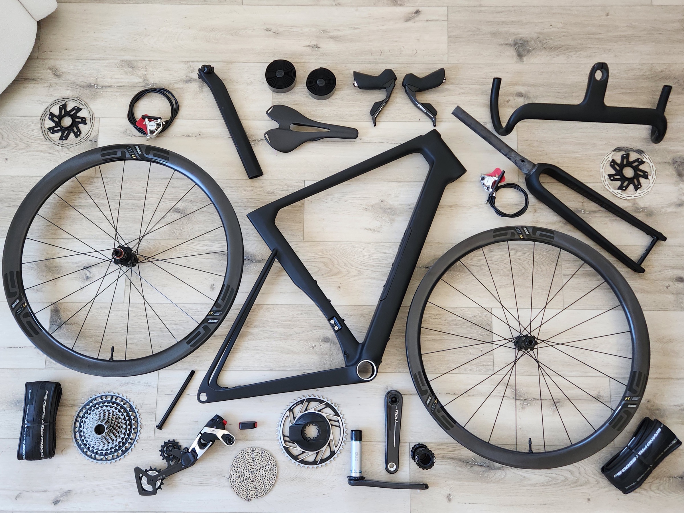 Apex carbon frameset, wheelset, cockpit and components arranged as a flat lay