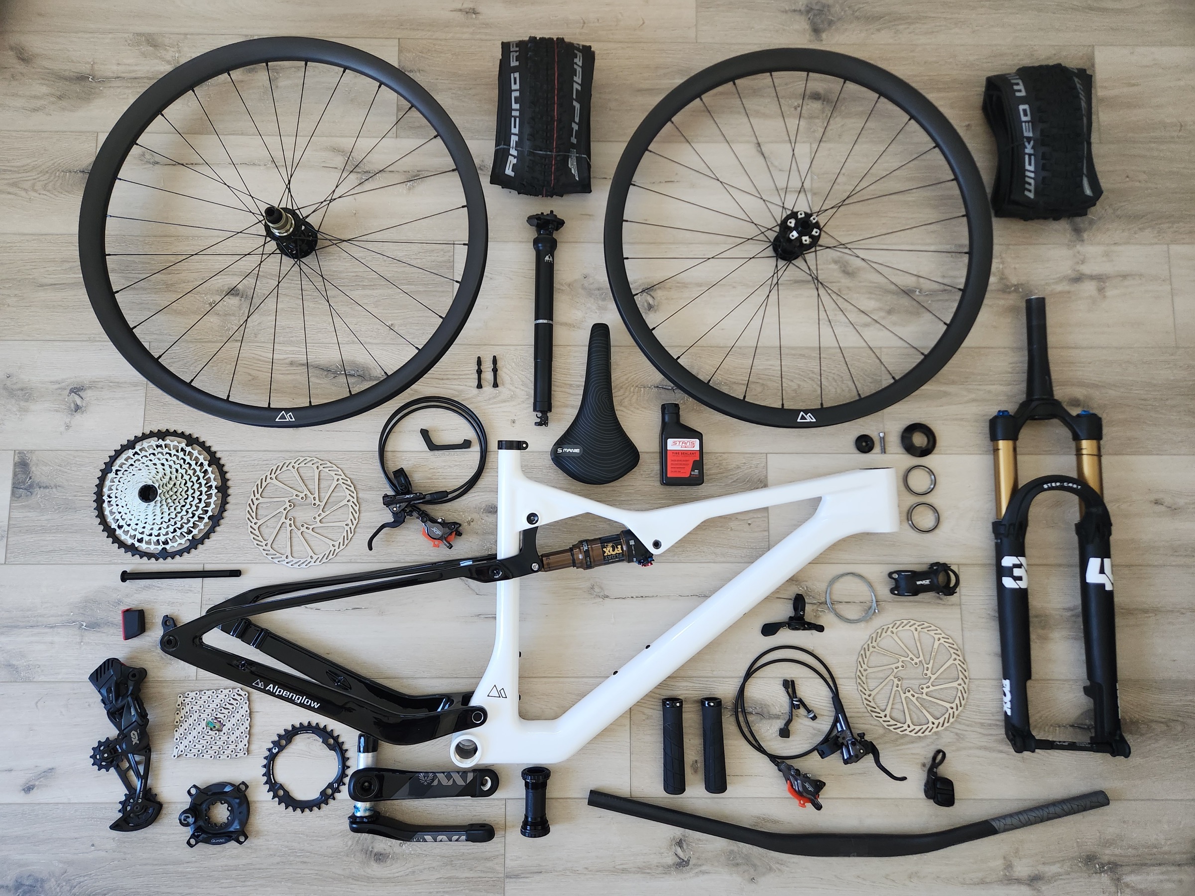 Ridge carbon frame, suspension, wheels and components arranged as a flat lay